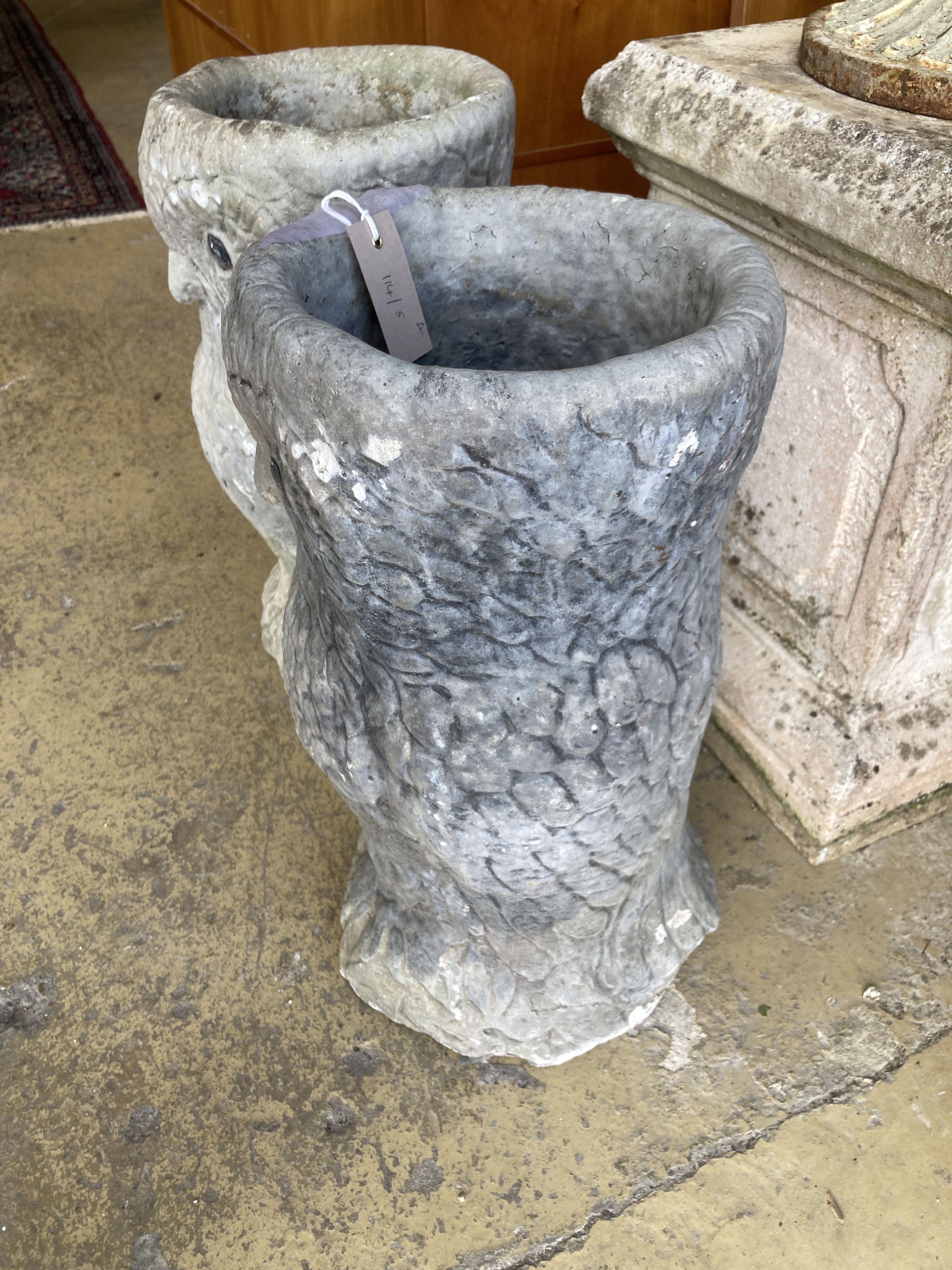 A pair of reconstituted stone owl garden planters, height 50cm
